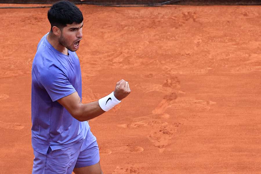 Carlos Alcaraz celebrates after beating Francisco Cerundolo