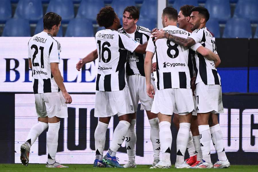 Vlahovic celebrates with his teammates after scoring