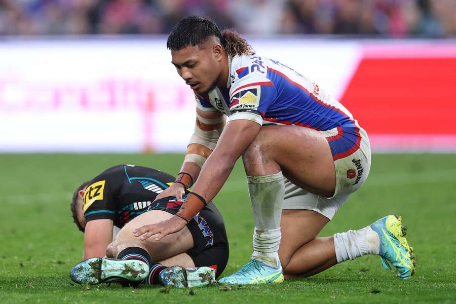 A distressed Phoenix Crossland waits with injured Nathan Cleary for medical staff to arrive. 
