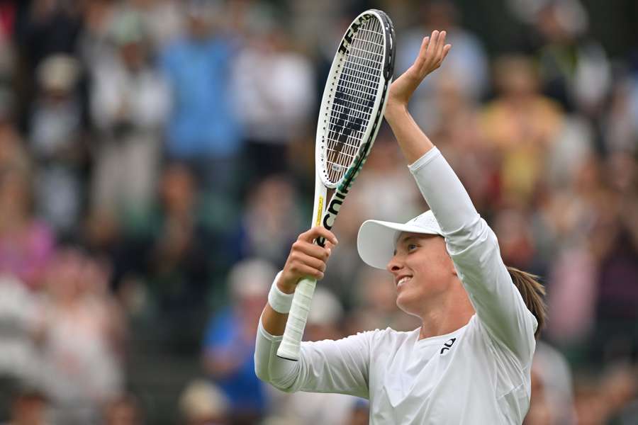 Iga Swiatek celebrates beating Zhu Lin to reach the second round