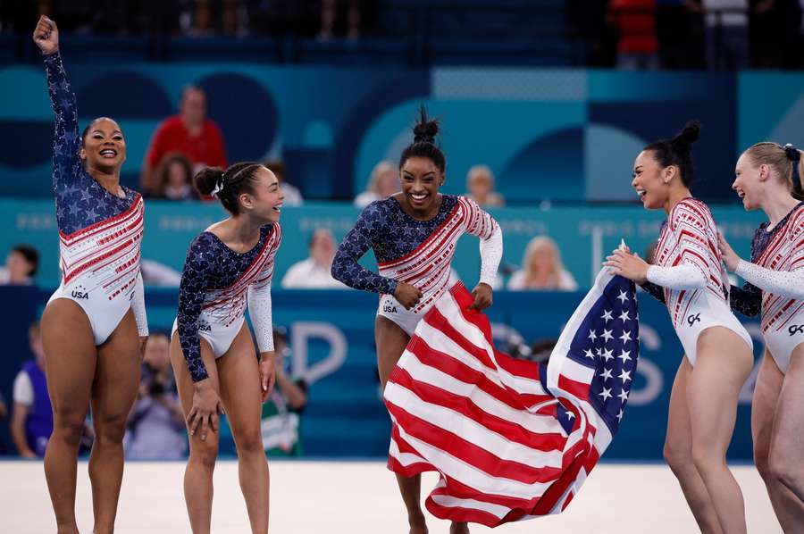 Simone Biles, Jordan Chiles, Jade Carey, Sunisa Lee and Hezly Rivera of the USA celebrate