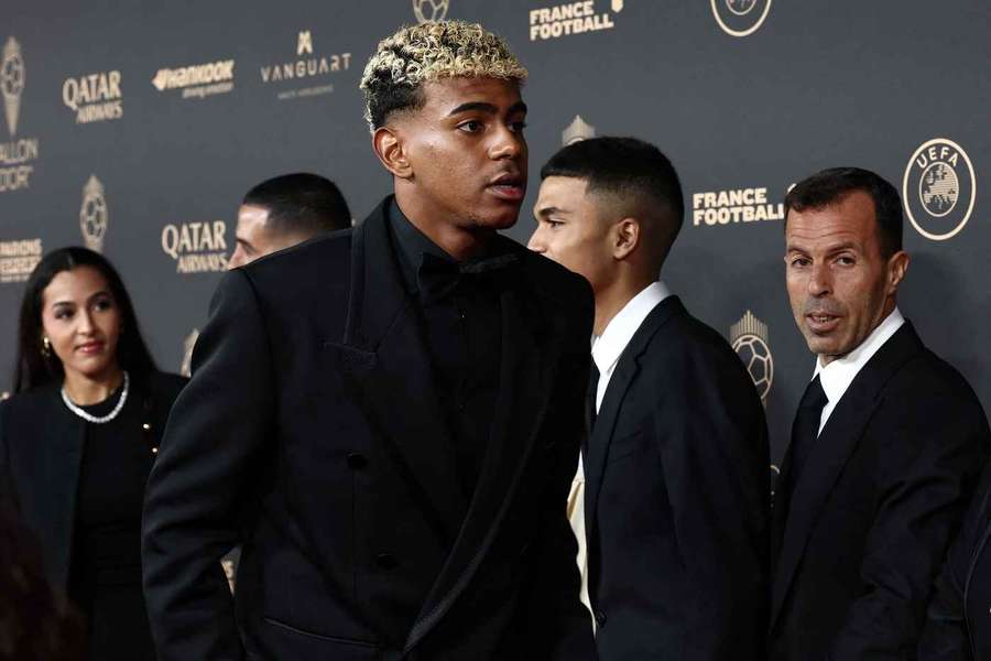 Barcelona's Spanish forward Lamine Yamal (C) poses upon arrival before the 2025 Ballon d'Or
