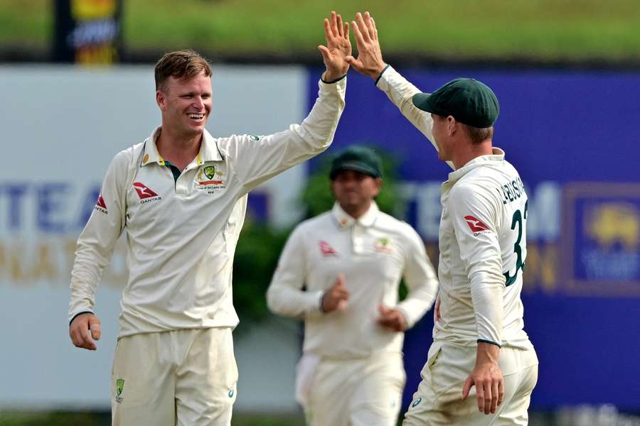 Australia's Matthew Kuhnemann (left) celebrates with teammates after taking the wicket of Sri Lanka's Jeffrey Vandersay