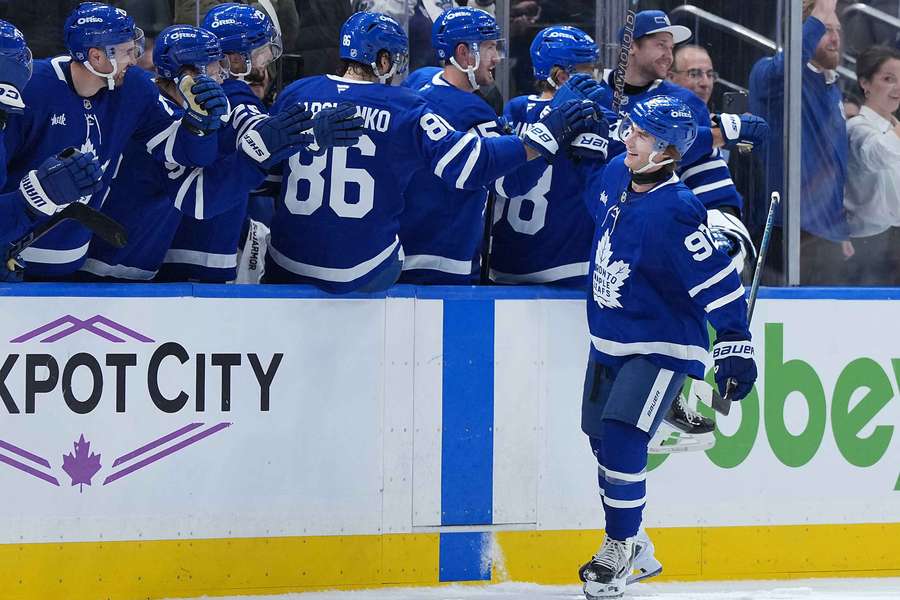 Gavin McKenna high-fives teammates after scoring first career goal