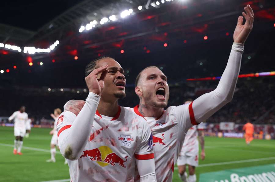 Leipzig's Xavi Simons (left) celebrates with David Raum after scoring against Dortmund