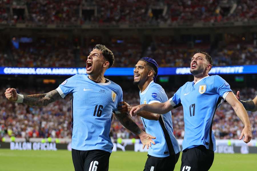 Mathias Olivera of Uruguay celebrates with teammates after scoring