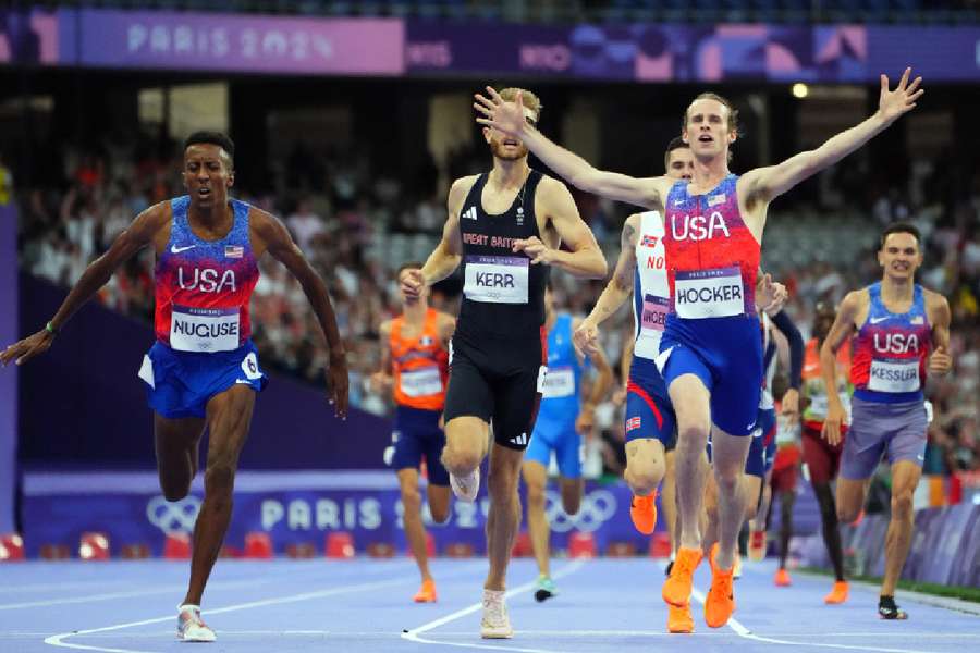 Cole Hocker of United States celebrates after crossing the line to win gold ahead of Josh Kerr of Britain and Yared Nuguse of United States