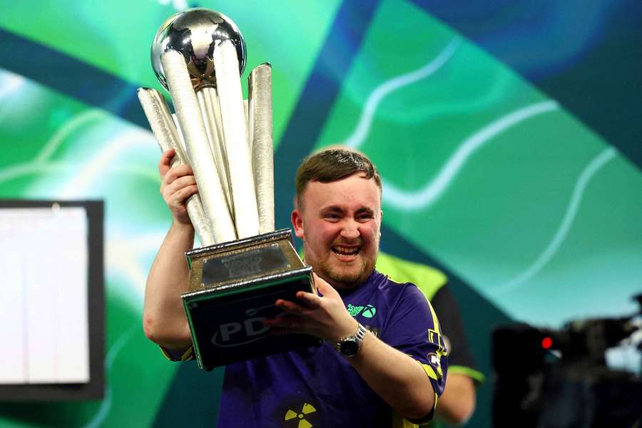 Luke Littler lifts the Sid Waddell trophy after winning the World Championship in January