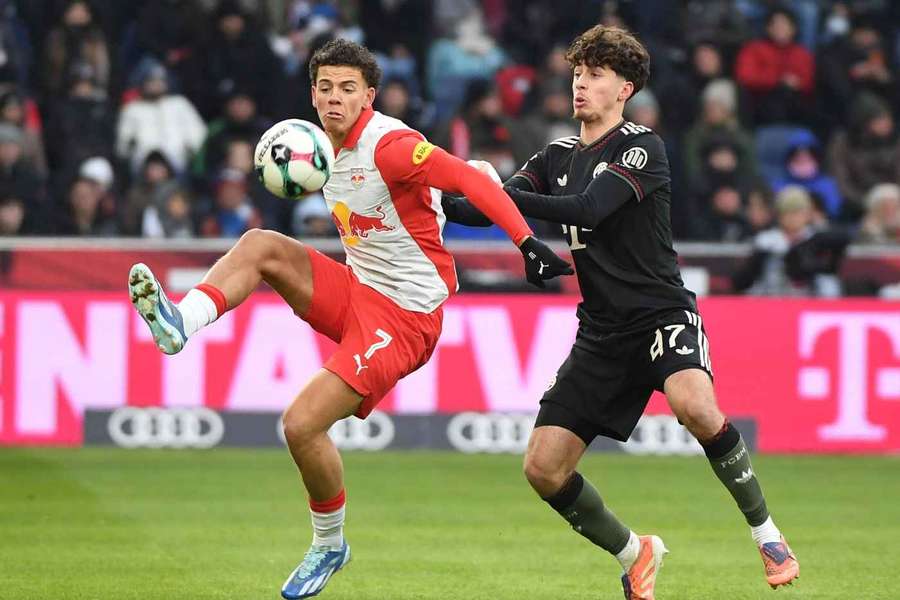 Clement Bischoff tangles with Bayern Munich's David Daiber during a friendly