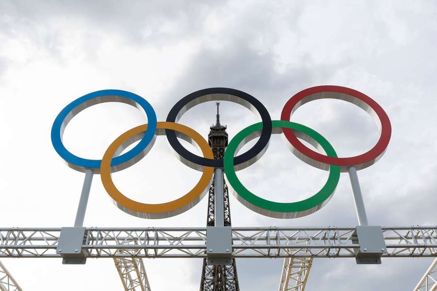 Os anéis olímpicos com a Torre Eiffel ao fundo