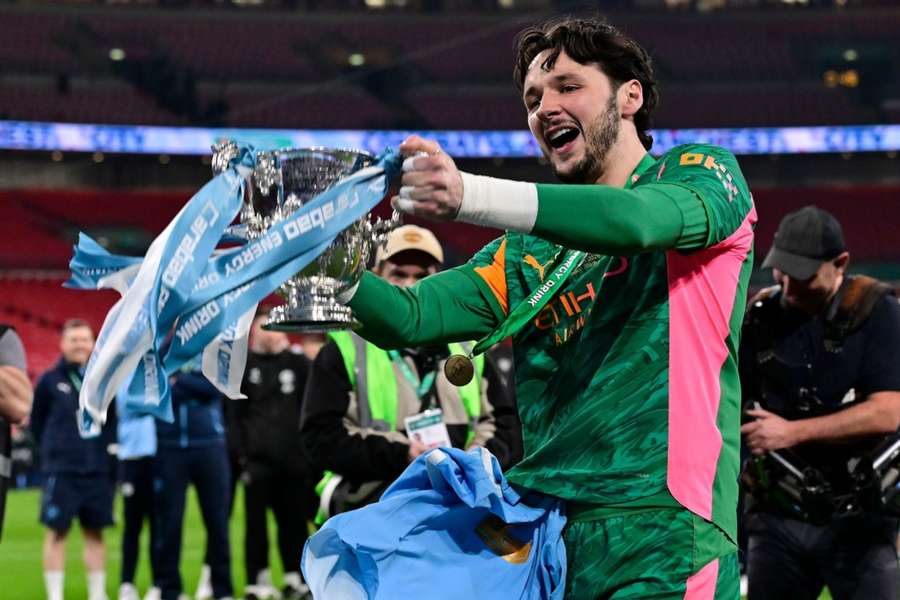 Man City's James Trafford celebrates with the Carabao Cup after beating Arsenal