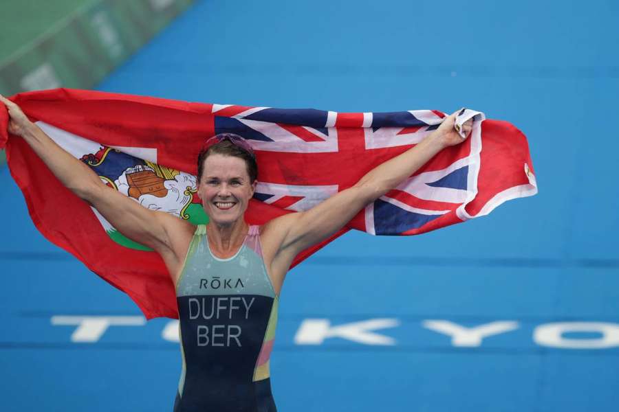 Flora Duffy of Bermuda holds national flag as she celebrates victory
