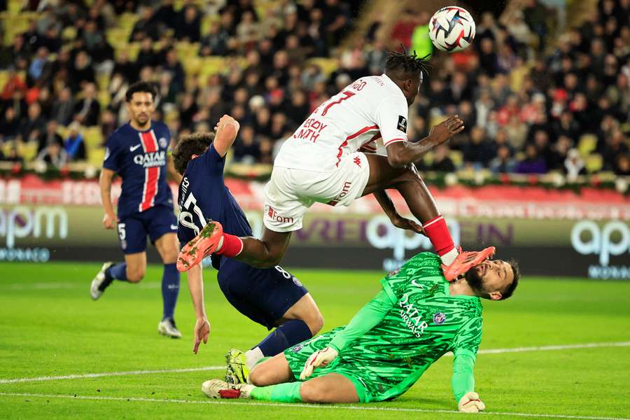 Singo attempts to jump over the onrushing Donnarumma