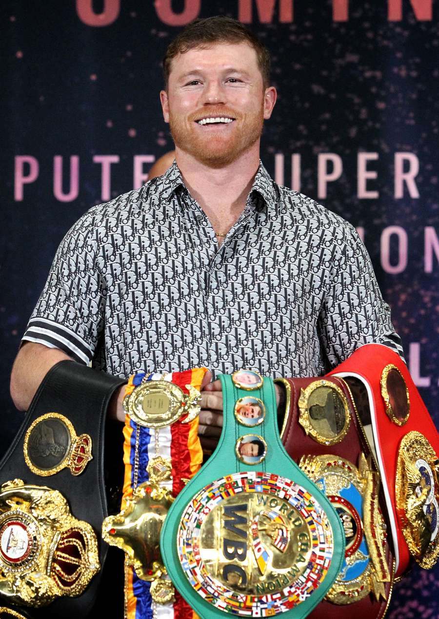 Canelo Alvarez poses with his belts during Tuesday's press conference