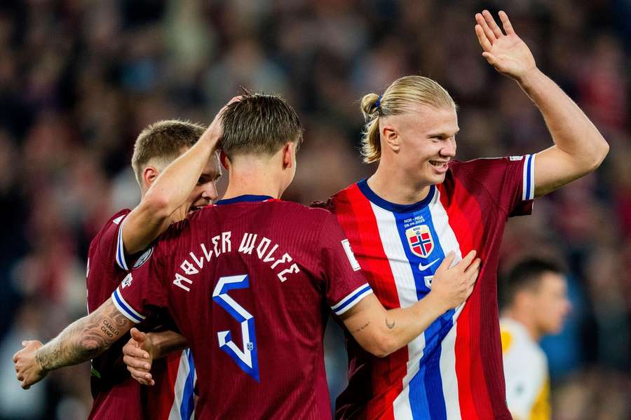 Norway's Erling Braut Haaland celebrates with Martin Odegaard and David Moller Wolfe in the win against Moldova