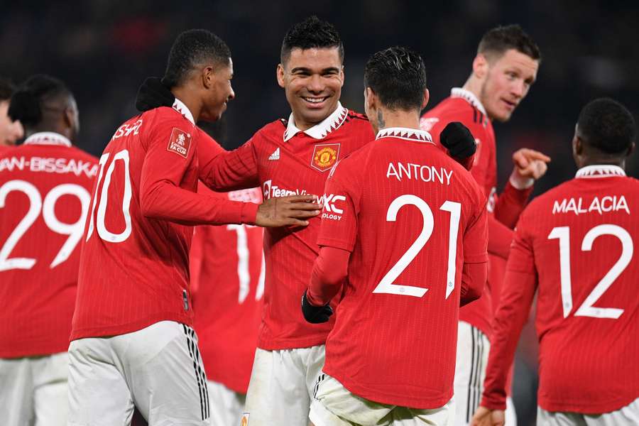Manchester United's Brazilian midfielder Casemiro celebrates with teammates after scoring their second goal 