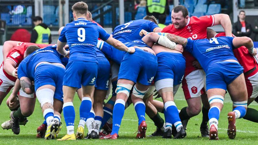 Wales' hooker Ken Owens (R) gets caught in a maul 