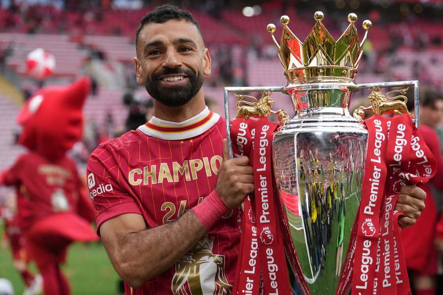 Liverpool's Mohamed Salah poses with the Premier League trophy