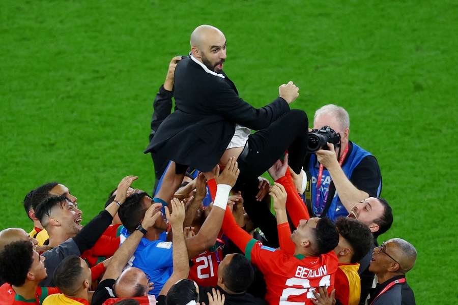 Morocco coach Walid Regragui celebrates with the players after the match as Morocco progress to the semi finals