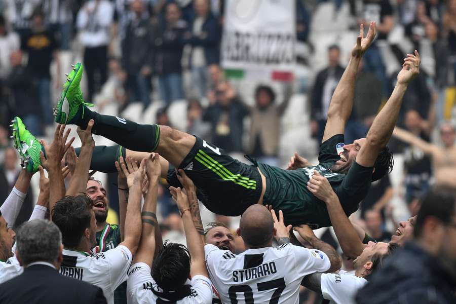 Juventus' goalkeeper from Italy Gianluigi Buffon is lifted in the air by teammates