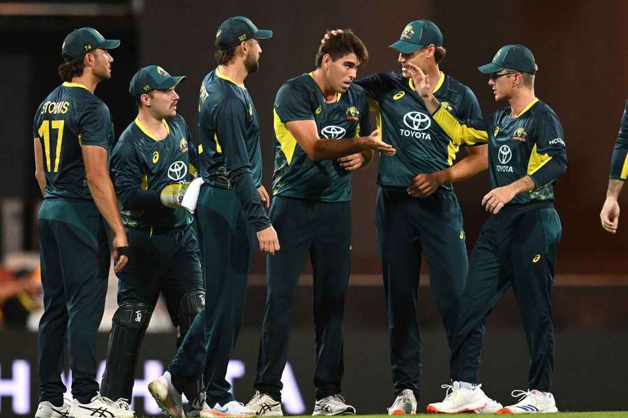 Xavier Bartlett of Australia celebrates with teammates after getting the wicket of Mohammad Rizwan of Pakistan