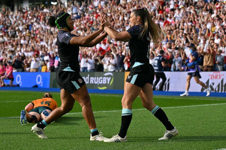 England's wing Jess Breach (R) celebrates after scoring their first try England's wing Jess Breach (R) celebrates after scoring their first try