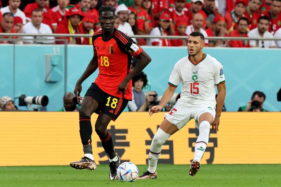 Le milieu de terrain belge Amadou Onana court avec le ballon devant le milieu de terrain marocain Selim Amallah lors du match du groupe F de la Coupe du Monde Qatar 2022 entre la Belgique et le Maroc au stade Al-Thumama à Doha, le 27 novembre 2022.