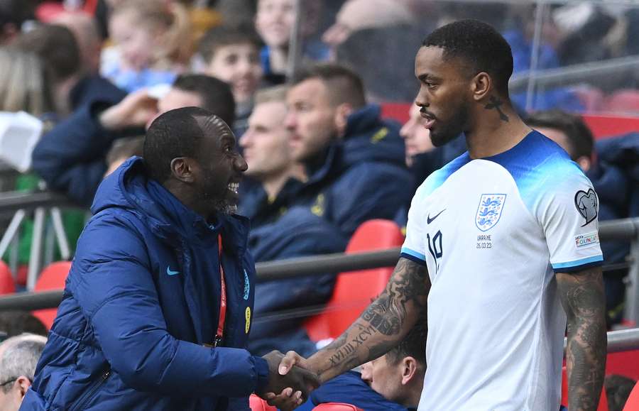 England's Dutch assistant coach Jimmy Floyd Hasselbaink shakes hands as England's striker Ivan Toney comes off the bench 