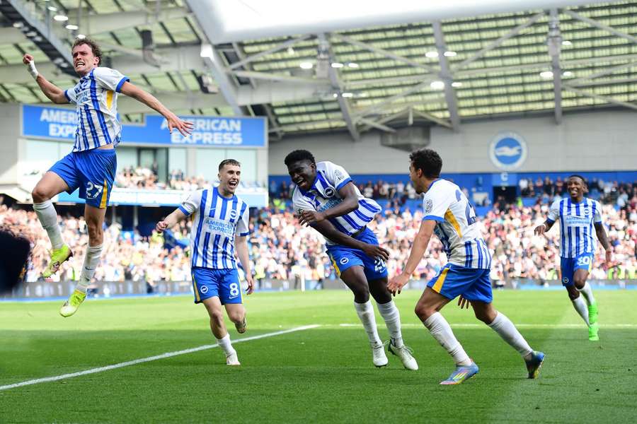 Brighton players celebrate with Carlos Baleba after he scored the winning goal against West Ham