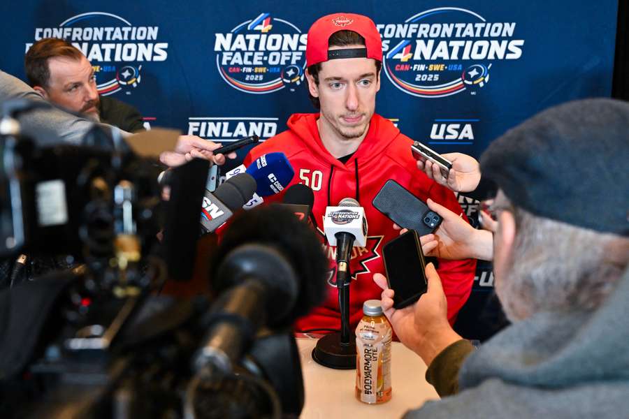 Team Canada goaltender Jordan Binninton talking to press members during 4 Nations Face-Off media day (2025)