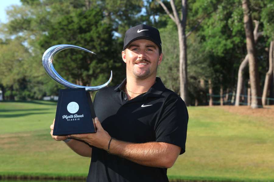 Gotterup poses with his first PGA Tour trophy