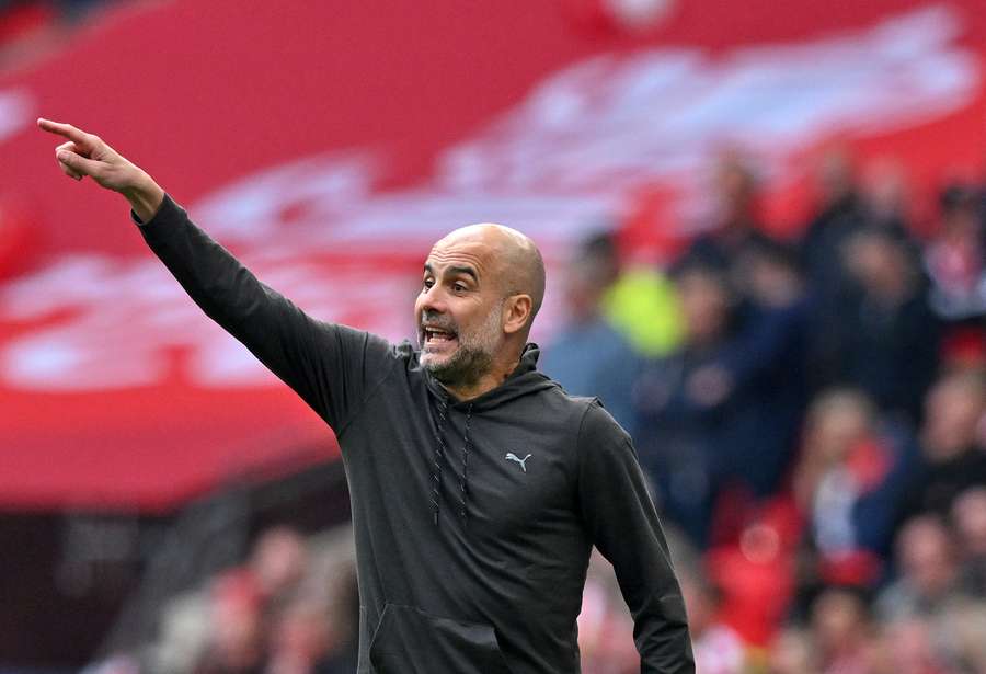 Pep Guardiola shouts instructions to the players from the touchline during the English FA Cup semi-final football match between Manchester City and Sheffield United