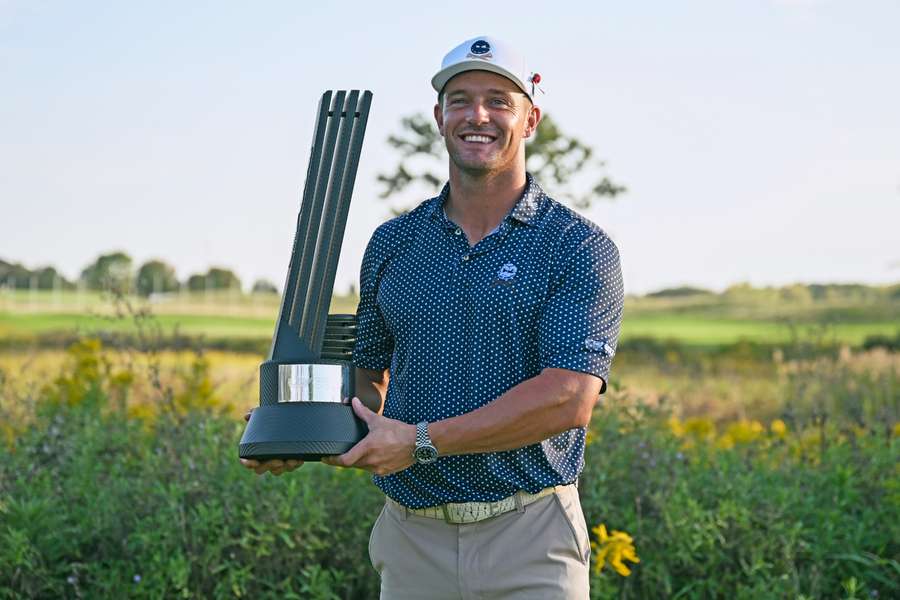 DeChambeau poses with the trophy after winning in Chicago