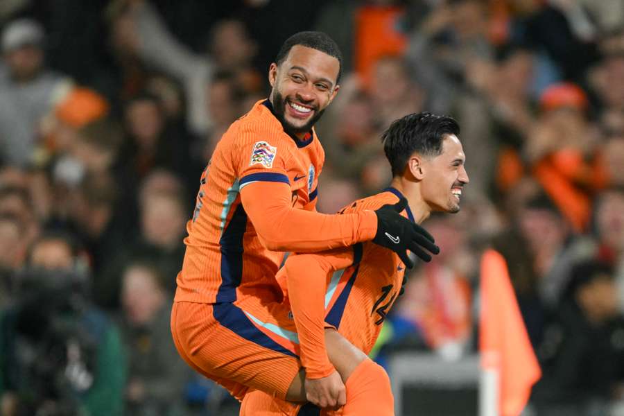 Netherlands' midfielder Tijjani Reijnders (right) celebrates with teammate Memphis Depay