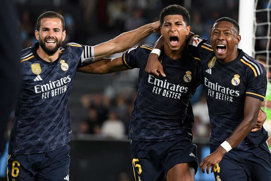 Real Madrid midfielder Jude Bellingham (C) celebrates his goal with defenders Nacho Fernandez and David Alaba