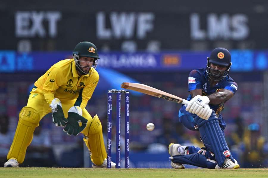 Sri Lanka's Kusal Perera (R) plays a shot as Australia wicketkeeper Josh Inglis watches