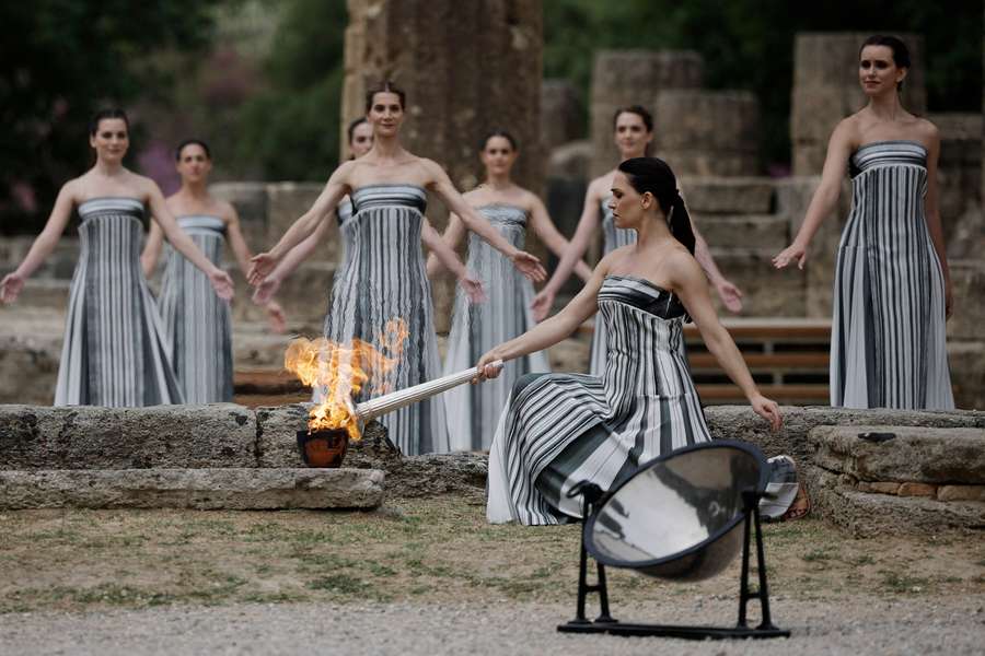 Greek actress Mary Mina, playing the role of High Priestess, lights the flame during the Olympic Flame lighting ceremony for the Paris 2024 Olympics