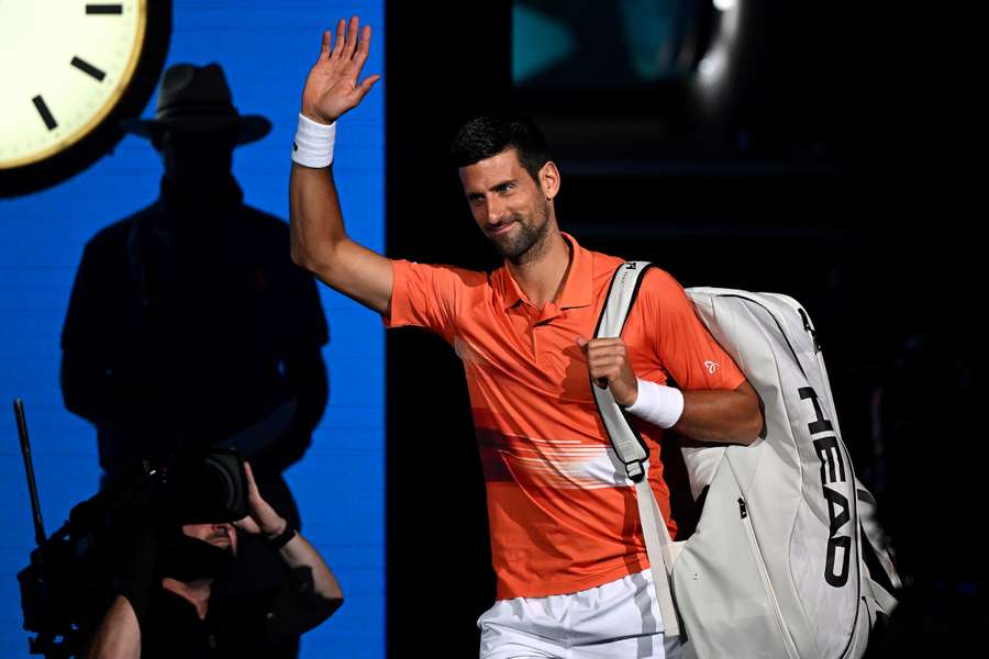 Novak Djokovic waves as he arrives to play an exhibition match against Nick Kyrgios