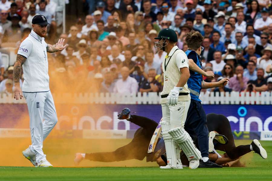 A protestor is tackled to the ground during the second Test