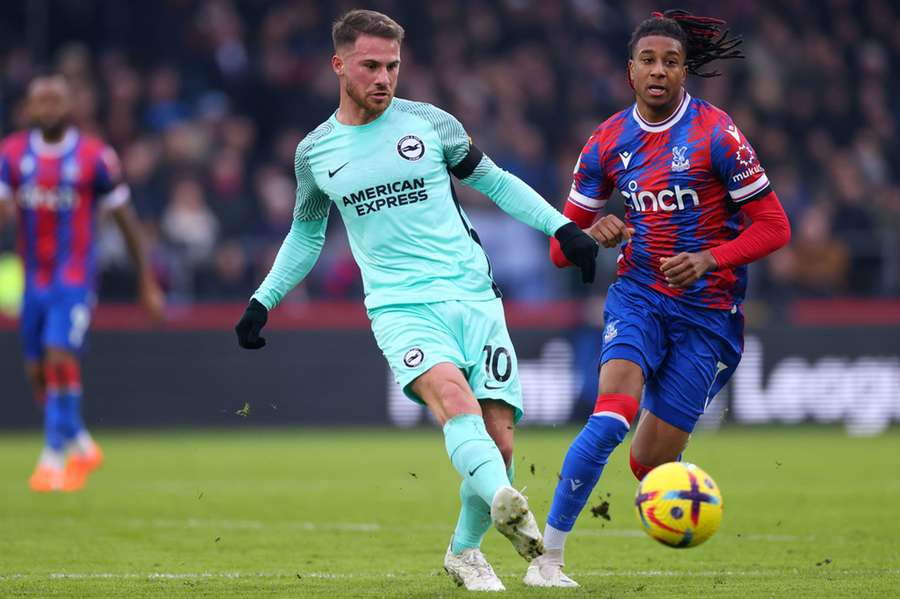 Alexis Mac Allister of Brighton and Hove Albion in action with Michael Olise of Crystal Palace