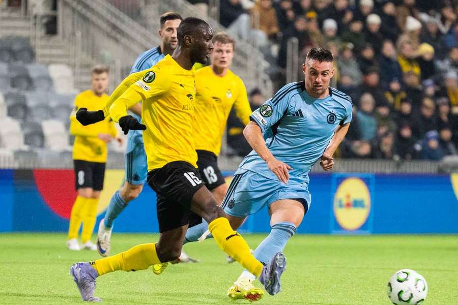 Ibrahim Cisse keeps the ball clear from Robert Mak Ibrahim Cisse keeps the ball clear from Robert Mak