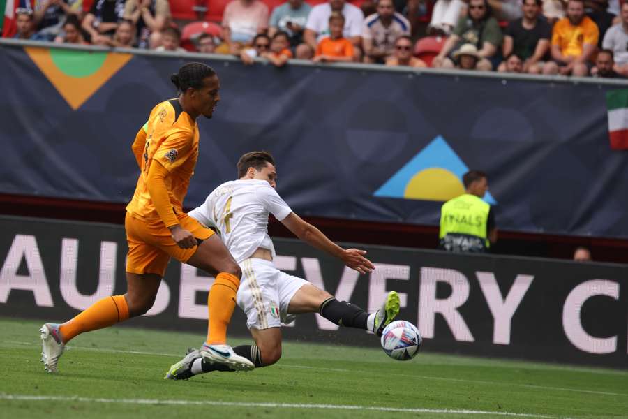 Italy forward Federico Chiesa (R) scores his team's third goal