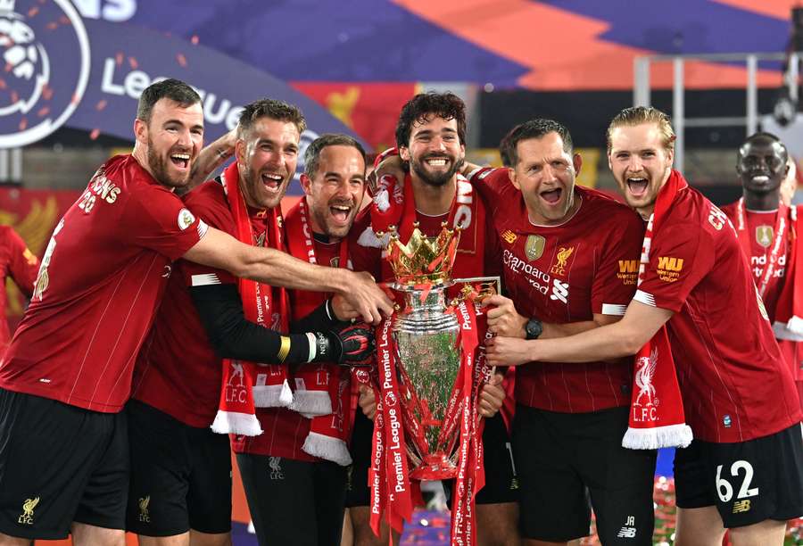 Liverpool's Andy Lonergan, Adrian, assistant goalkeeping coach Jack Robinson, Alisson Becker, goalkeeping coach John Achterberg and Caoimhin Kelleher celebrate with the Premier League trophy