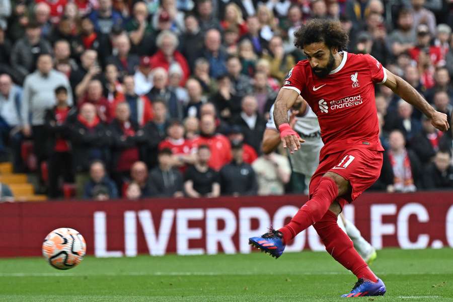 Liverpool's Egyptian striker #11 Mohamed Salah scores the opening goal from the penalty spot