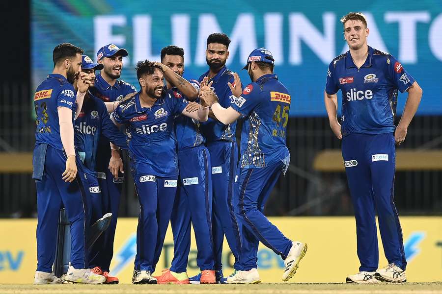 Mumbai Indians' Akash Madhwal (4L) celebrates with teammates after the dismissal of Lucknow Super Giants' Mohsin Khan 