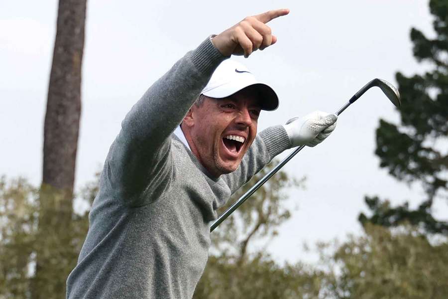Rory McIlroy celebrates after a hole-in-one on the 15th hole on the first round