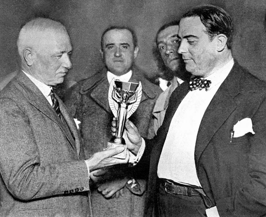 Jules Rimet (a sinistra) consegna il trofeo della Coppa del Mondo al capo della federazione uruguaiana Raul Jude Jules Rimet (a sinistra) consegna il trofeo della Coppa del Mondo al capo della federazione uruguaiana Raul Jude