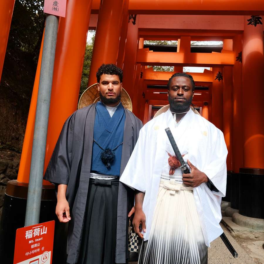 Thomas Odukoya with fellow Tennessee Titans tight end Chigoziem Okonkwo, right, in Japan