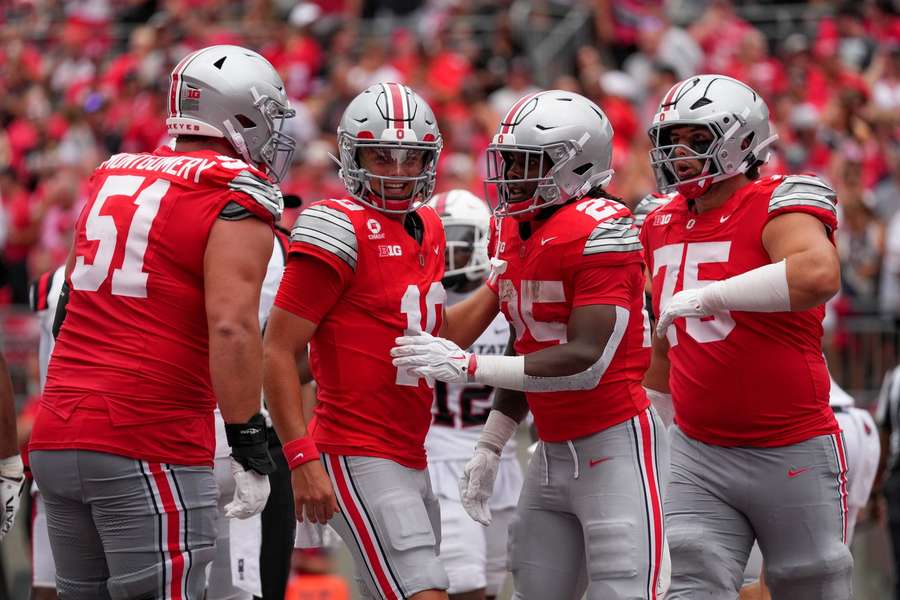 Julian Sayin and his Ohio State teammates talk during their game against Ball State Julian Sayin and his Ohio State teammates talk during their game against Ball State