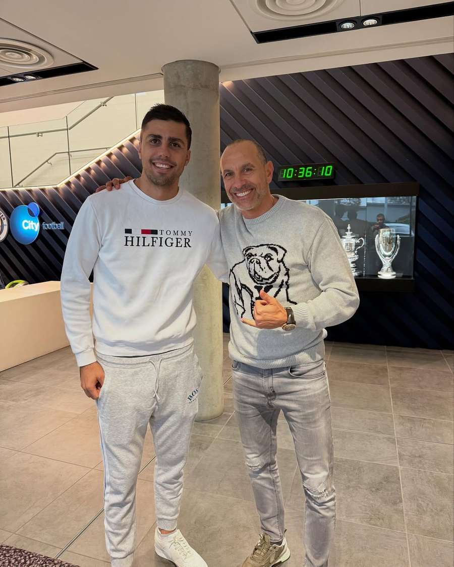 Martin Petrov (R) alongside Manchester City midfielder Rodri